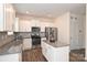 Bright kitchen features white cabinets, stainless appliances, granite countertops, and a convenient center island at 4010 Richard Andrew Dr, Matthews, NC 28105