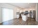 Modern kitchen features stainless steel appliances, gray countertops, wood floors, and a center island at 4010 Richard Andrew Dr, Matthews, NC 28105
