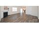 The living room features hardwood floors with a view of the kitchen at 4010 Richard Andrew Dr, Matthews, NC 28105