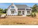 Charming farmhouse with white siding, black metal awnings and roof, and fresh landscaping at 5020 Carolina North Dr, Gastonia, NC 28056