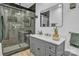Modern bathroom features a glass-enclosed shower, stylish gray vanity with a white countertop, and sleek black accents at 530 Wilmot Trl, Gastonia, NC 28056