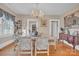Formal dining room with hardwood floors, elegant chandelier, and charming furnishings at 530 Wilmot Trl, Gastonia, NC 28056