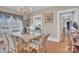 A sunlit dining room boasts hardwood floors and decorative chandelier lighting at 530 Wilmot Trl, Gastonia, NC 28056