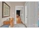 An inviting entryway features a wooden dresser, stylish wall art, and an open doorway, enhancing the home's charm at 530 Wilmot Trl, Gastonia, NC 28056