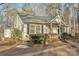 Exterior view of the home featuring a charming front porch and detailed landscaping at 530 Wilmot Trl, Gastonia, NC 28056