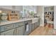 The stylish kitchen boasts updated appliances, cabinets with gold hardware, and a farmhouse sink at 530 Wilmot Trl, Gastonia, NC 28056