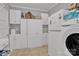 This laundry room is fitted with ample white cabinets, a modern washing machine, and tile flooring for practical use at 530 Wilmot Trl, Gastonia, NC 28056