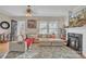 Inviting living room featuring a cozy fireplace, plush sectional sofa, and ample natural light at 530 Wilmot Trl, Gastonia, NC 28056