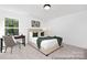 The bedroom has carpet flooring, a window view, and a study desk and chair at 680 Candela Ct # 52, York, SC 29745