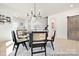 Dining area with black modern chairs, round table, barn door, and light wood flooring at 680 Candela Ct # 52, York, SC 29745
