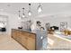Bright, airy kitchen with a view into the living room, featuring stylish counters and an expansive island at 680 Candela Ct # 52, York, SC 29745