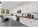 Modern kitchen featuring white cabinets, countertops, and a view into the living room with stainless appliances at 680 Candela Ct # 52, York, SC 29745