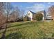 Expansive backyard with lush grass and mature trees, providing a serene outdoor space at 7007 Church Wood Ln, Huntersville, NC 28078