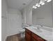 Bathroom with white sink, wood vanity and shower-tub combo at 7007 Church Wood Ln, Huntersville, NC 28078