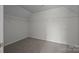 Empty bedroom with neutral carpet and shelving; ready for customization at 7007 Church Wood Ln, Huntersville, NC 28078