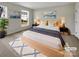 Cozy bedroom with neutral decor, featuring a comfortable bed, tasteful artwork, and a bright window at 7007 Church Wood Ln, Huntersville, NC 28078