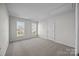 Bright bedroom with neutral walls, carpet flooring, and two windows at 7007 Church Wood Ln, Huntersville, NC 28078