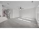 Expansive bonus room with neutral carpet, ceiling fan, providing a versatile space for relaxation or entertainment at 7007 Church Wood Ln, Huntersville, NC 28078