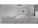 Spacious bonus room with ceiling fan, neutral carpet, and abundant natural light from multiple windows at 7007 Church Wood Ln, Huntersville, NC 28078