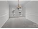 Elegant dining room featuring a chandelier, neutral carpet, and large windows at 7007 Church Wood Ln, Huntersville, NC 28078