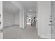 Bright entryway with neutral carpet, white walls, stairway, and ample natural light streaming through at 7007 Church Wood Ln, Huntersville, NC 28078