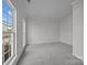 Inviting living room with neutral carpet, large windows offering natural light, and freshly painted walls at 7007 Church Wood Ln, Huntersville, NC 28078