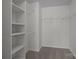 Organized walk-in closet with white shelving and carpet flooring at 7007 Church Wood Ln, Huntersville, NC 28078