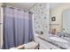 Charming bathroom featuring a shower with curtain, granite countertop, and a toilet at 710 Ben Ave, Kannapolis, NC 28081