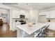 Open kitchen with white cabinets, quartz countertops, stainless steel appliances, and a large island at 7921 Old Brook Rd, Sherrills Ford, NC 28673