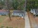 An aerial view of a well-maintained, single-story home with a driveway and a small front yard at 901 Yellowstone Dr, Charlotte, NC 28208