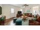 Cozy living room featuring hardwood floors, a leather sofa, and stylish decor at 901 Yellowstone Dr, Charlotte, NC 28208