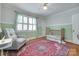 Cozy Bedroom with patterned wallpaper, green trim, and hardwood flooring at 968 Waverly Ave, Rock Hill, SC 29730