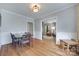 Open dining area featuring hardwood floors, white wainscoting, and views into living room at 968 Waverly Ave, Rock Hill, SC 29730