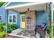 Inviting covered porch with wicker chairs, patterned rug, brick accents, and yellow front door at 968 Waverly Ave, Rock Hill, SC 29730