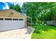 Garage with a patio area surrounded by a lush green lawn and mature trees at 968 Waverly Ave, Rock Hill, SC 29730