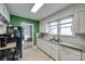 Bright kitchen featuring white cabinets, granite countertops, stainless steel appliances, and tile flooring at 968 Waverly Ave, Rock Hill, SC 29730