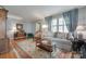 Bright living room with hardwood floors, neutral sofa, patterned rug, and large window with shutter-style blinds at 968 Waverly Ave, Rock Hill, SC 29730