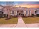 Charming single-story home features manicured lawn, welcoming porch, and stylish shutters at sunset at 11135 Bailey Park Nature Dr, Cornelius, NC 28031