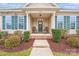 Charming front porch featuring comfortable seating, decorative accents, and well-maintained landscaping around the entrance at 11135 Bailey Park Nature Dr, Cornelius, NC 28031