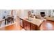 Kitchen island with granite countertops, stainless steel sink, dark wood cabinetry, and wood flooring at 11135 Bailey Park Nature Dr, Cornelius, NC 28031