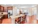 Open-concept kitchen island featuring granite countertops, a sink, seating, and stainless steel appliances at 11135 Bailey Park Nature Dr, Cornelius, NC 28031