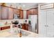 Well-equipped kitchen with stainless steel appliances, granite countertops, and ample dark wood cabinetry at 11135 Bailey Park Nature Dr, Cornelius, NC 28031
