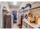 Organized walk-in closet with shelving and hanging space for clothes, storage, and accessories at 11135 Bailey Park Nature Dr, Cornelius, NC 28031