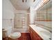 Bathroom featuring linoleum floors, double sink vanity, a shower-tub combo, and a toilet at 113 2Nd St, Spencer, NC 28159