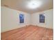 Bedroom featuring hardwood floors, natural light from two windows, and neutral paint at 113 2Nd St, Spencer, NC 28159