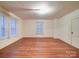 Bedroom with hardwood floors, natural light from two windows, and neutral paint at 113 2Nd St, Spencer, NC 28159