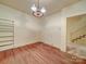 Room with hardwood floors, vintage lighting, and staircase access, ready for customization at 113 2Nd St, Spencer, NC 28159