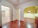 Dining room with brick floors, vintage hanging light fixture and view to another room at 113 2Nd St, Spencer, NC 28159