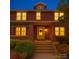 Charming two-story brick home with inviting front porch and illuminated windows at dusk at 113 2Nd St, Spencer, NC 28159