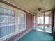 Inviting screened front porch with brick accents and a ceiling fan fixture at 113 2Nd St, Spencer, NC 28159